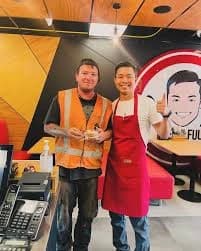 Picture of sam and a customer in their kitchen smiling